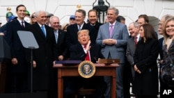 FILE - President Donald Trump, Canada's Prime Minister Justin Trudeau, right, and Mexico's then-President Enrique Pena Nieto, left, participate in the USMCA signing ceremony, Nov. 30, 2018, in Buenos Aires. Trump will sign U.S. legislation Wednesday.