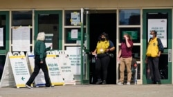 FILE - A woman walks into Ohio's COVID-19 mass vaccination clinic at Cleveland State University, Tuesday, May 25, 2021, in Cleveland.