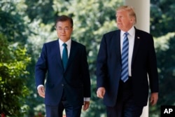 FILE - U.S. President Donald Trump walks with South Korean President Moon Jae-in to make statements at the White House in Washington, June 30, 2017.