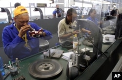 FILE - Diamonds are polished at the Krochmal and Cohen diamond factory in Johannesburg.