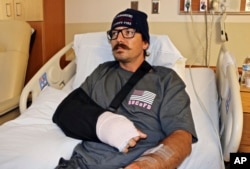 Mike Kordich, a firefighter from Rancho Cucamonga, Calif., answers questions from his hospital bed at Sunrise Hospital in Las Vegas, Oct. 3, 2017. Kordich was giving a severely injured person CPR when he was hit by a bullet.