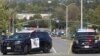 Police cars are seen after a deadly shooting at Geneva Presbyterian Church in Laguna Woods