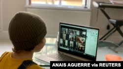 A school kid socializes with peers online following school closures due the spread of the coronavirus disease (COVID-19) outbreak, in London, Britain, March 20, 2020 in this picture obtained from social media on March 25, 2020. Anais Aguerre/via…