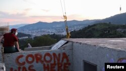 People walk in a pedestrian area in Barcelona, Spain, May 5, 2020. 