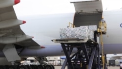 FILE - In this photo released by the Taiwan Centers for Disease Control, workers unload COVID-19 vaccines from a China Airlines cargo plane from Memphis that arrived at the airport outside Taipei in Taiwan, June 20, 2021.