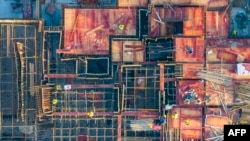 FILE - This aerial photo taken on Oct. 26, 2023, shows workers at a construction site in Huaian, in China's eastern Jiangsu province. Jiangsu authorities are encouraging workers at state-owned enterprises to take leave without pay to start their own businesses.