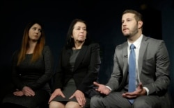 FILE - Christine Levinson, center, wife of Robert Levinson, and her children, Dan and Samantha Levinson, talk to reporters in New York, Jan. 18, 2016.