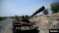 FILE - A tank damaged during the fighting between Ethiopia's National Defense Force and Tigray Special Forces stands on the outskirts of Humera, Ethiopia, July 1, 2021. 