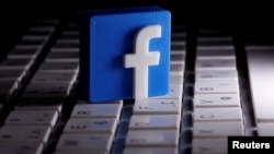 A 3D-printed Facebook logo is seen placed on a keyboard in this illustration taken March 25, 2020.