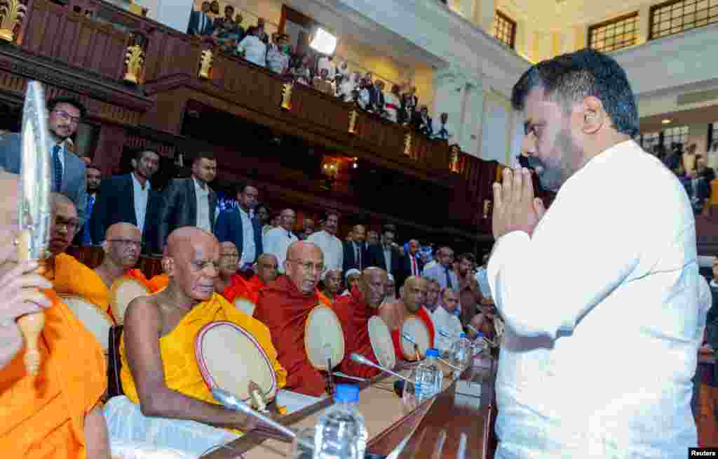 Buddhist monks chant religious hymns as they bless Sri Lanka's new President Anura Kumara Dissanayake after he took his oath of office at the Presidential Secretariat, in Colombo, Sri Lanka. (Sri Lanka President Media/Handout via Reuters)