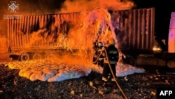 This photograph taken and released by Ukrainian Emergency Service on Oct. 6, 2023, shows firefighters working to extinguish a fire on the port infrastructure on the Danube River, in the Odesa region, amid the Russian invasion in Ukraine. (Ukrainian Emergency Service via AFP)