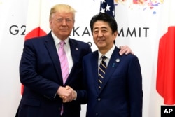 President Donald Trump meets with Japanese Prime Minister Shinzo Abe during a meeting on the sidelines of the G-20 summit in Osaka, Japan, June 28, 2019.