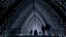 Visitors walk through the 'Cathedral' on the Christmas light trail as it returns for its 12th year, with a showcase of new installations set within the UNESCO World Heritage Site landscape of Kew Gardens in London, England, Nov. 12, 2024. 
