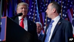 FILE - President-elect Donald Trump (L) stands with Republican National Committee Chairman Reince Priebus during an election night rally in New York, Nov. 9, 2016, as Vice president-elect Mike Pence (background) looks on. Trump named Priebus his White House chief of staff.