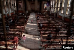 FILE - Believers gather at a government-sanctioned Catholic church before mass in Youtong, Hebei province, China, March 25, 2018.