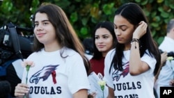 Students walk to class at Marjory Stoneman Douglas High School in Parkland, Fla., Feb. 28, 2018. Students returned to class for the first time since a former student opened fire there with an assault weapon. (AP Photo/Terry Renna)