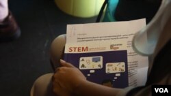 A student holding is seen holding a “STEM Careers of the Future” guide book in Phnom Penh on Feb 17, 2016. (Hean Socheata/ VOA Khmer)