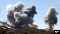 FILE - This undated photo released by the Army Times March 5, 2002, shows smoke rising from Taliban and al-Qaida positions in the hills of Sirkankel, Afghanistan, after heavy U.S. bombing.