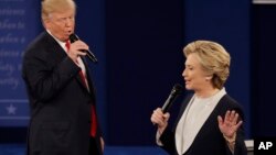 FILE - Republican presidential nominee Donald Trump and Democratic presidential nominee Hillary Clinton speak during the second presidential debate at Washington University in St. Louis, Sunday, Oct. 9, 2016. (AP Photo/Patrick Semansky)