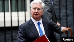 FILE - Britain's Minister of Defense Michael Fallon leaves 10 Downing Street after a cabinet meeting, in London, Britain, June 27, 2017.
