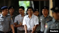 Police escort detained Reuters journalists Kyaw Soe Oo and Wa Lone as they arrive before a court hearing in Yangon, Myanmar, Aug. 20, 2018.