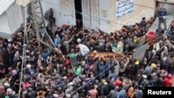 Palestinians gather to receive bread from a bakery, amid the Israel-Hamas conflict, amid the ongoing conflict between Israel and Hamas, in Deir Al-Balah in the central Gaza Strip, Nov. 29, 2024. 