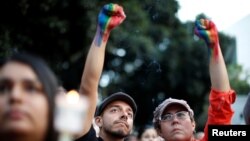People attend a vigil in memory of victims one day after a mass shooting at the Pulse gay night club in Orlando, in Los Angeles, California, June 13, 2016.