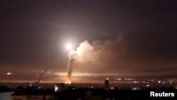 Missile fire is seen from Damascus, Syria, May 10, 2018. Israel said Thursday its fighter jets struck dozens of Iranian military targets inside of Syria overnight in response to what it said were Iranian rocket attacks on Israeli targets in the Golan Heights.