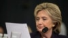 FILE - Democratic presidential candidate, former Secretary of State Hillary Rodham Clinton looks at an email sent by Ambassador Chris Stevens during her testimony before the House Benghazi Committee.