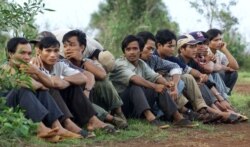 FILE PHOTO - Montagnards who recently fled Vietnam's Central Highlands wait in Senmonorom in Mondolkiri province which borders Vietnam, May 15, 2001.