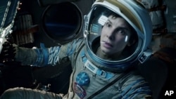 This film image released by Warner Bros. Pictures shows Sandra Bullock in a scene from "Gravity." Bullock says making the lost-in-space movie directed by Alfonso Cuaron was her “best life decision” ever.