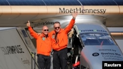 Andre Borschberg (R), the Swiss pilot of Solar Impulse 2, is greeted by fellow pilot and countryman Bertrand Piccard after landing at Cairo Airport, Egypt, July 13, 2016.