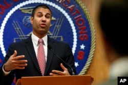 FILE - Federal Communications Commission Chairman Ajit Pai answers a question from a reporter after a meeting where commissioners voted to end net neutrality, in Washington, Dec. 14, 2017.