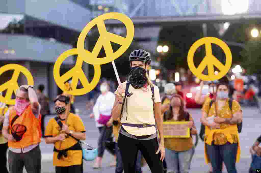 Mary Hubert, part of a "wall of moms," holds a peace sign during a Black Lives Matter rally, July 22, 2020, in Portland, Oregon.