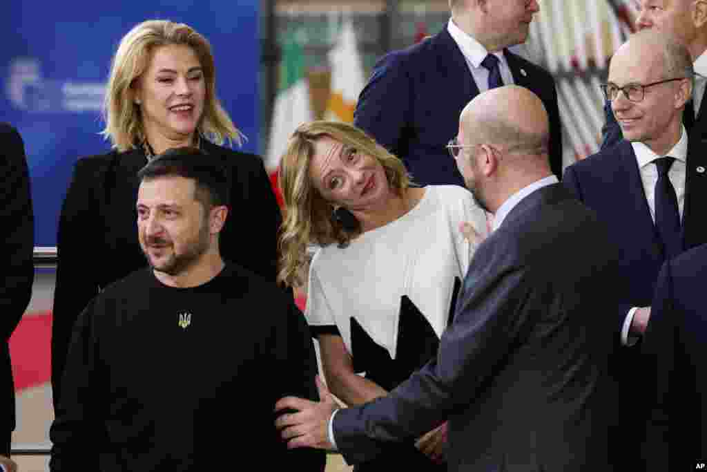 European Council President Charles Michel, 2nd right, talks to Italy's Prime Minister Giorgia Meloni, center, Ukraine's President Volodymyr Zelenskyy, bottom left, as they arrive for a group photo during an EU summit in Brussels, Belgium.