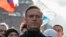 FILE - Alexei Navalny takes part in a rally to mark the 5th anniversary of opposition politician Boris Nemtsov's murder and to protest against proposed amendments to the country's constitution, in Moscow, Feb. 29, 2020.