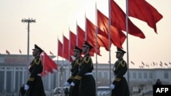 FILE - Chinese People's Liberation Army soldiers patrol at Tiananmen Square in Beijing, March 7, 2024.