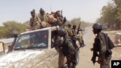 FILE - In this 2015 photo, Cameroon soldiers check a truck on the border between Cameroon and Nigeria as they combat regional Islamic extremists force's including Boko Haram.