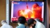  People watch a TV broadcasting file footage of a news report on North Korea firing what appeared to be a pair of ballistic missiles off its east coast, in Seoul, South Korea, September 15, 2021.