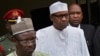 Incumbent President Muhammadu Buhari, center, leaves his party's headquarters after holding an emergency meeting with senior members of the All Progressives Congress (APC) in Abuja, Nigeria, Feb. 18, 2019. 