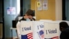 A man wears a face mask as he votes at an early voting site in Arlington, Virginia, U.S., September 18, 2020. 