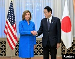 U.S. House of Representatives Speaker Nancy Pelosi shakes hands with Japan's Prime Minister Fumio Kishida before their breakfast meeting in Tokyo