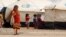 Displaced children, who fled from the Islamic State violence, gather at a refugee camp in the Makhmour area near Mosul, Iraq, June 17, 2016. 