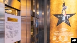 A sign explaining the cancellations of 'Hamilton' due to COVID-19 cases at the Richard Rodgers Theatre in the Broadway area of New York City, December 17, 2021.(AP Photo/Yuki Iwamura) 