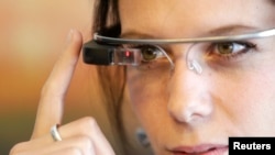 A woman wears Google glasses after a media presentation of a Google apartment in Prague May 15, 2014.
