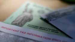 FILE - This April 23, 2020, file photo shows President Donald J. Trump's name printed on a stimulus check issued by the IRS to help combat the adverse economic effects of the new coronavirus outbreak in San Antonio. The Mexican American Legal…