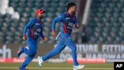 د افغانستان د کرکټ ملي ټیم کپتان حشمت الله شهیدي او توپ اچوونکی راشد خان