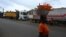 A woman selling carrots walks past trucks from Mali and Burkina Faso as they wait to load goods in the industrial area near Abidjan, Jan. 30, 2025, a day after Burkina Faso, Mali and Niger officially left the Economic Community of West African States, commonly known as ECOWAS.