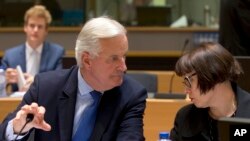 FILE - European Union chief Brexit negotiator Michel Barnier, left, speaks with EU Deputy Chief Negotiator Sabine Weyand during a meeting of EU General Affairs, Article 50, ministers in Brussels on Monday, Sept. 25, 2017.