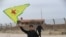 A Syrian Kurd waves the flag of YPG (People's Protection Units) near Qamishli's airport in northeastern Syria on December 8, 2024, following the fall of the capital Damascus to anti-government fighters.